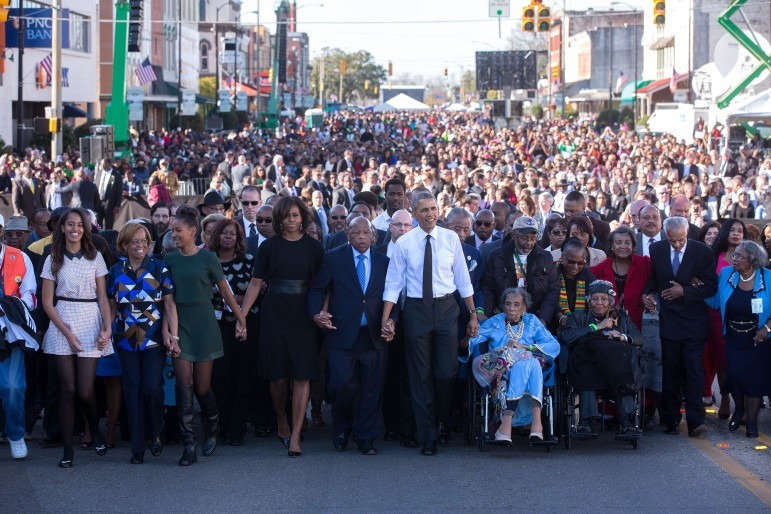The Obama family join hands as they begin the march with the foot soldiers across the Edmund Pettus Bridge. 