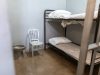 a bunk bed with striped foam mattress in a prison cell